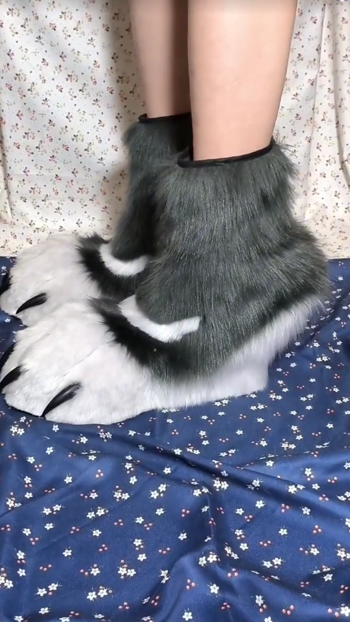 Black and white patterned fursuit feet with black claws and black paw pads, large furry paws