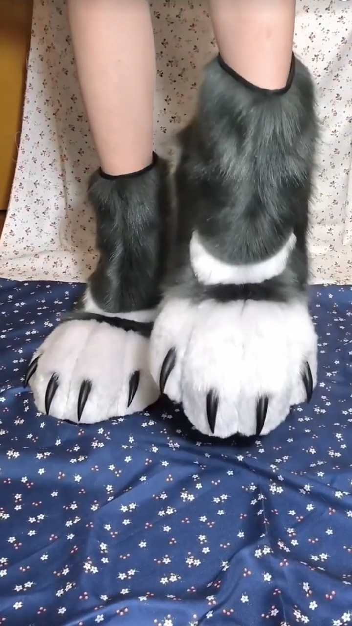 Black and white patterned fursuit feet with black claws and black paw pads, large furry paws