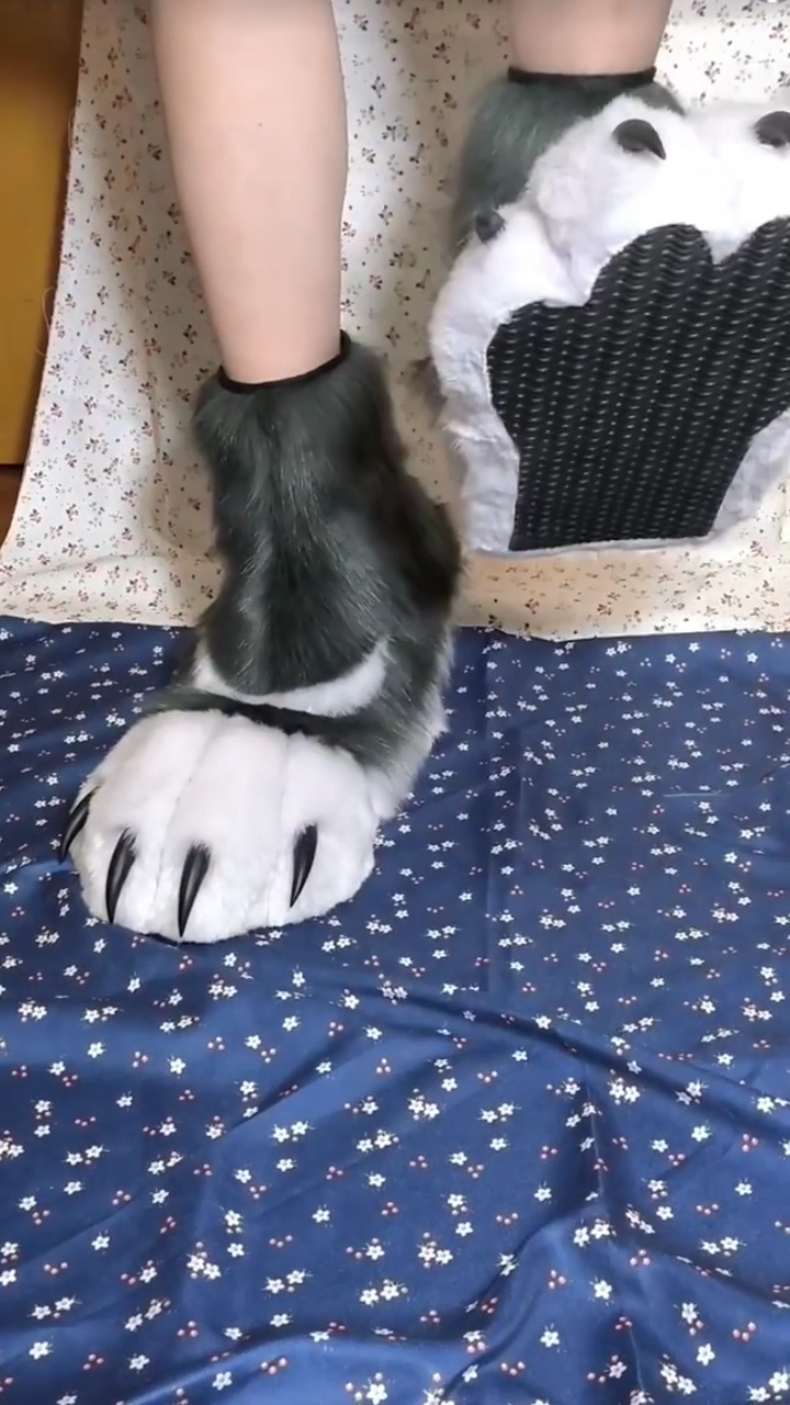 Black and white patterned fursuit feet with black claws and black paw pads, large furry paws